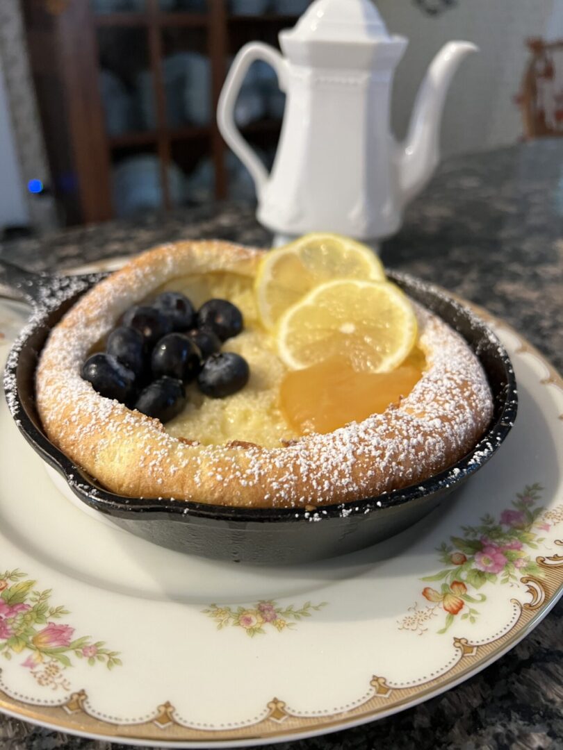 A lemon and blueberry pie is sitting on the table.
