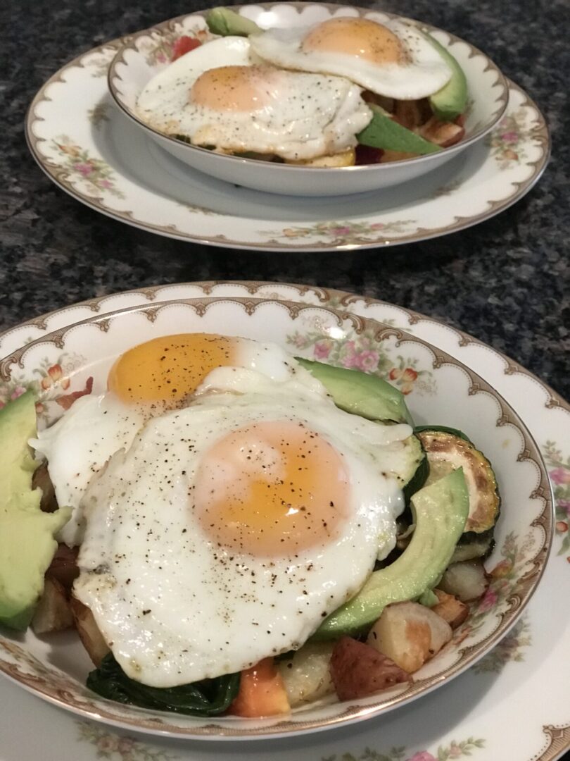 Two plates of food with an egg on top.
