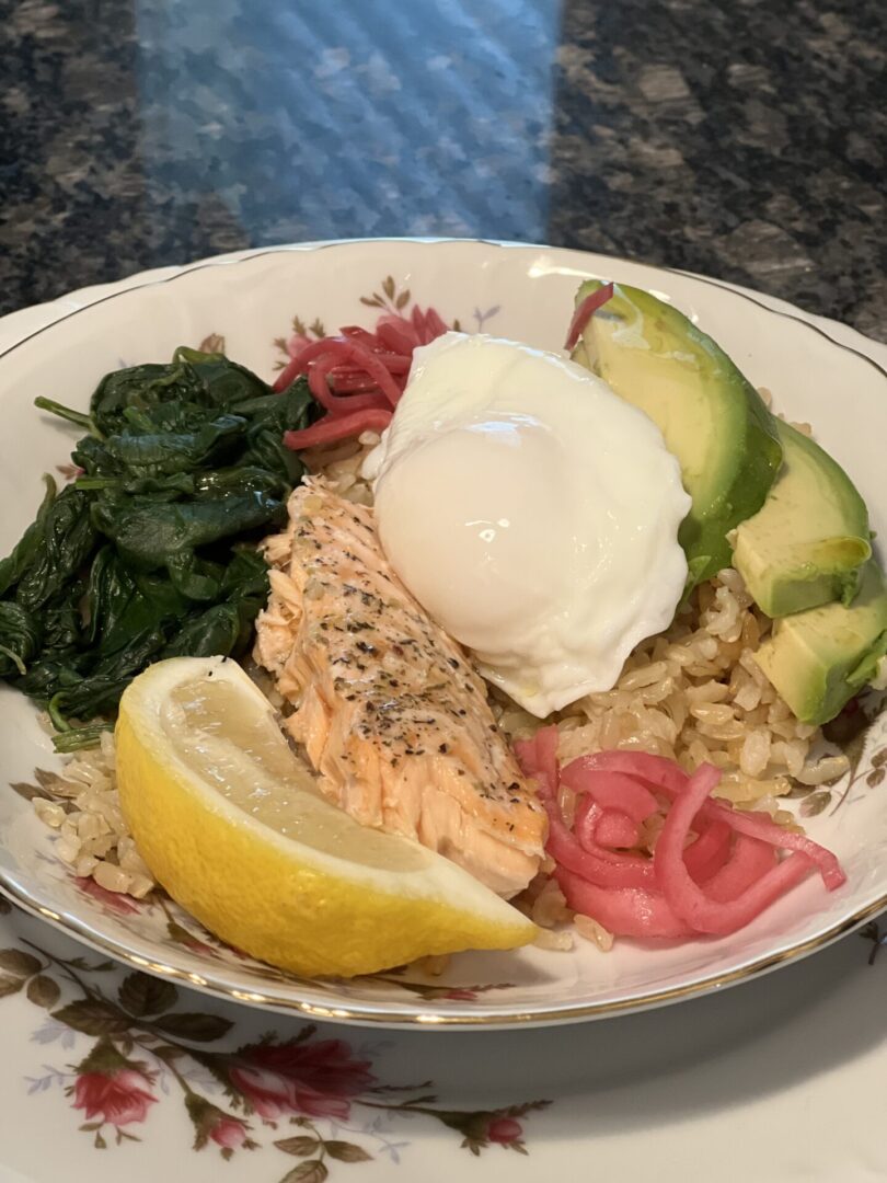 A plate of food with salmon, rice and an egg.