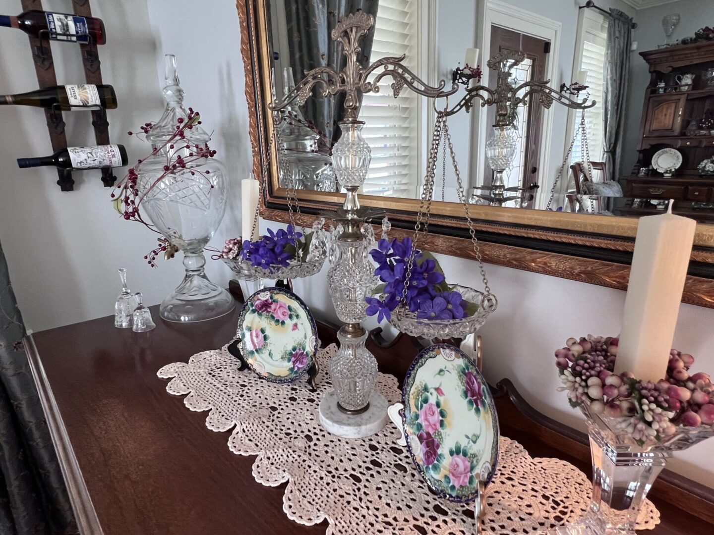 A table with two vases and a mirror